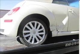 White VW Beetle with side damage, before repair
