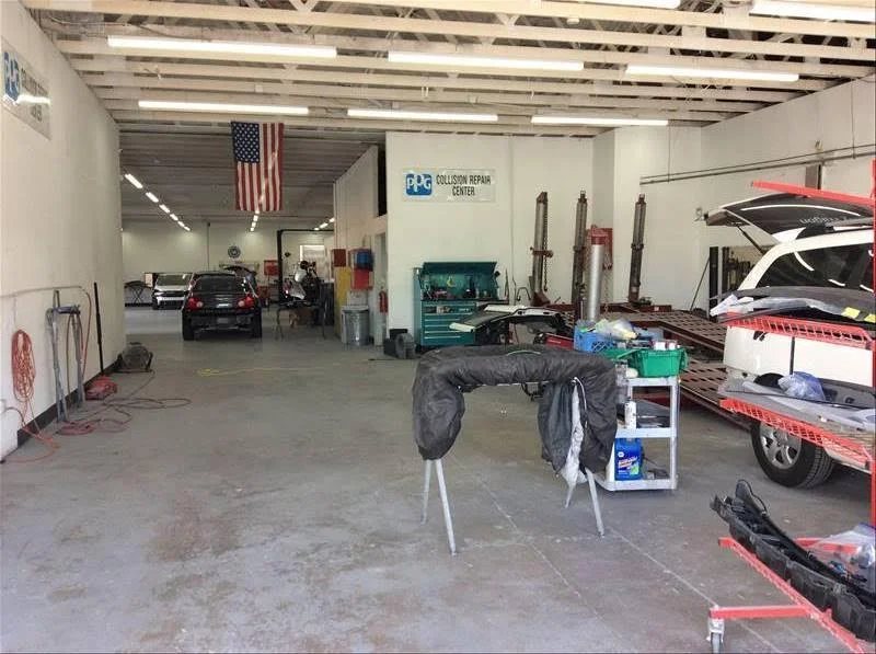 Work area with a vehicle being disassembled and parts racks